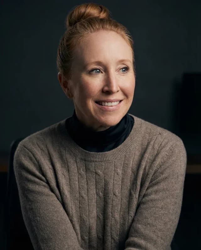 AI Graphic Designer Headshot of a 45 woman by ExecHeadshots